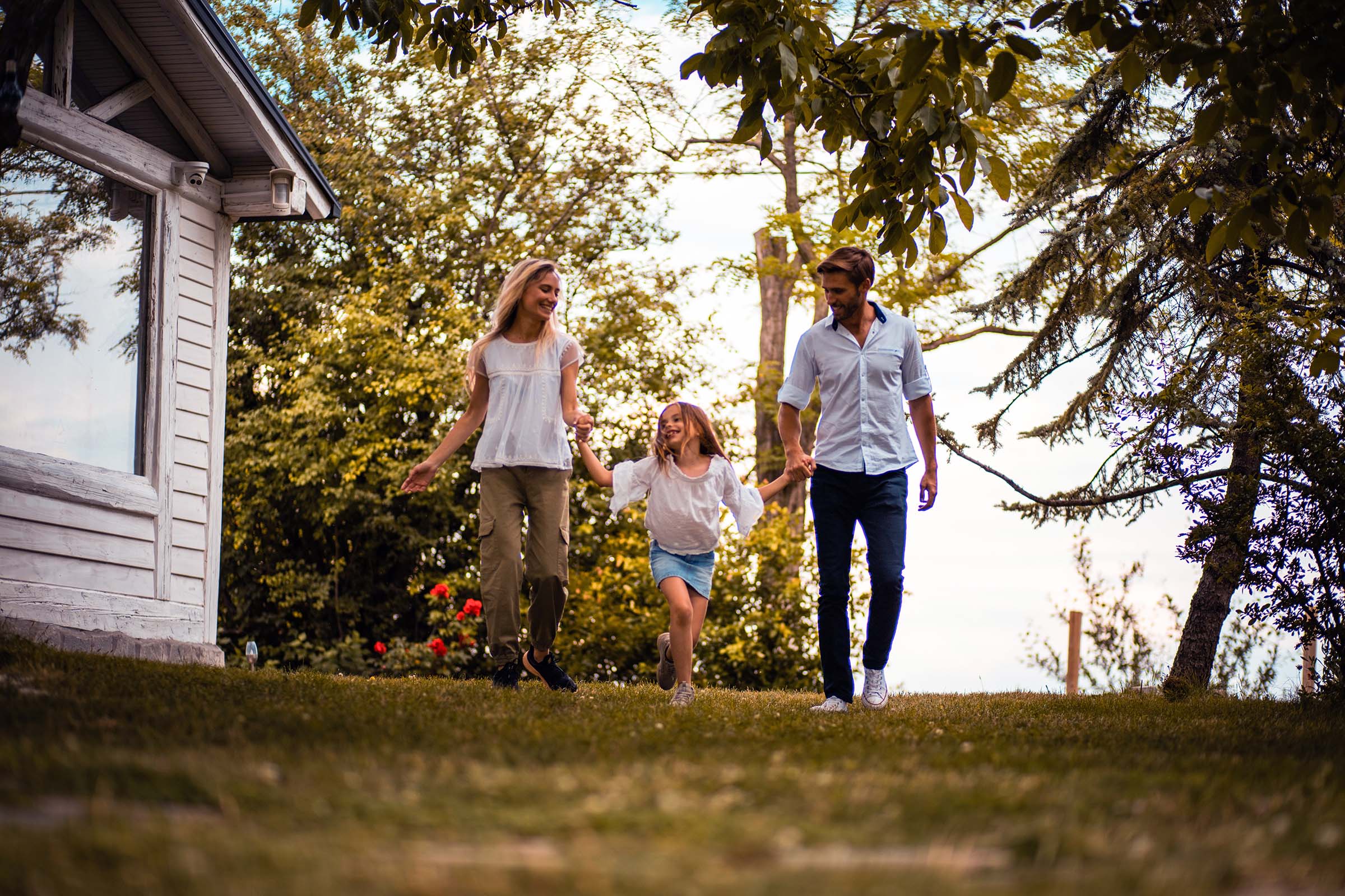 family holding hands in backyard_red_color-balance