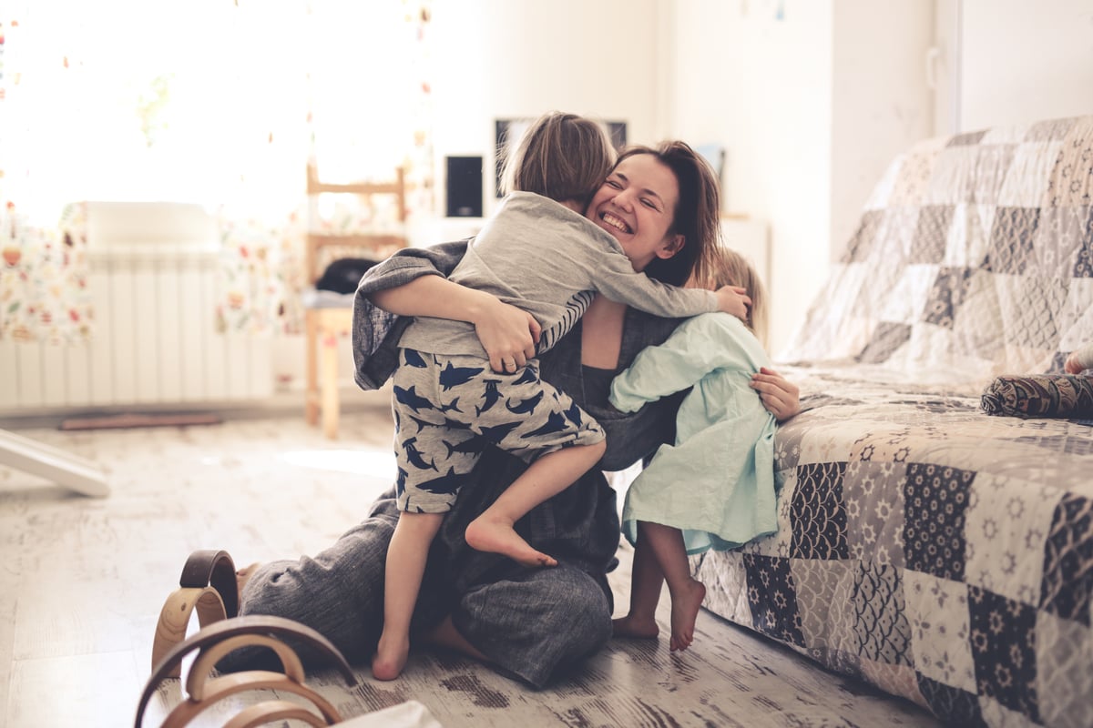 happy mom with two children sitting